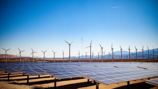 Field of solar panels and windmills in the desert