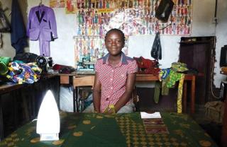 Figure 1. A woman working as an apprentice in a tailor’s shop connected to the hydroelectric grid in Democratic Republic of Congo